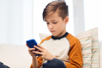 Boy playing game on smart phone