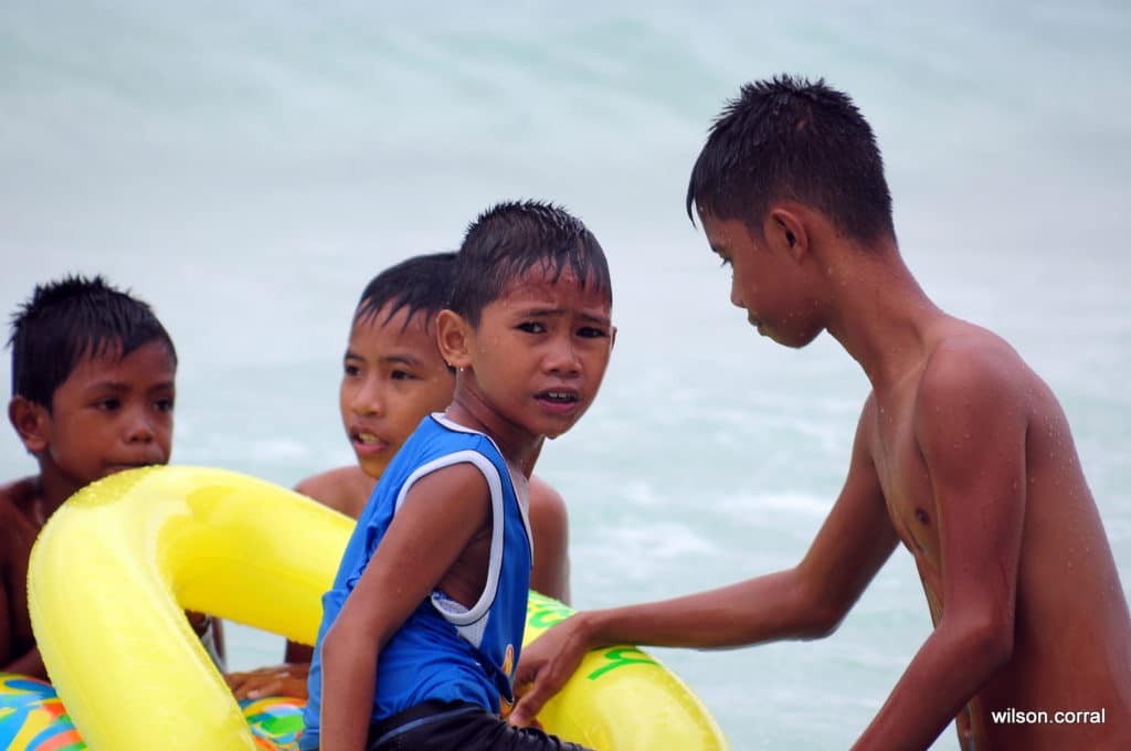 Boys playing in ocean