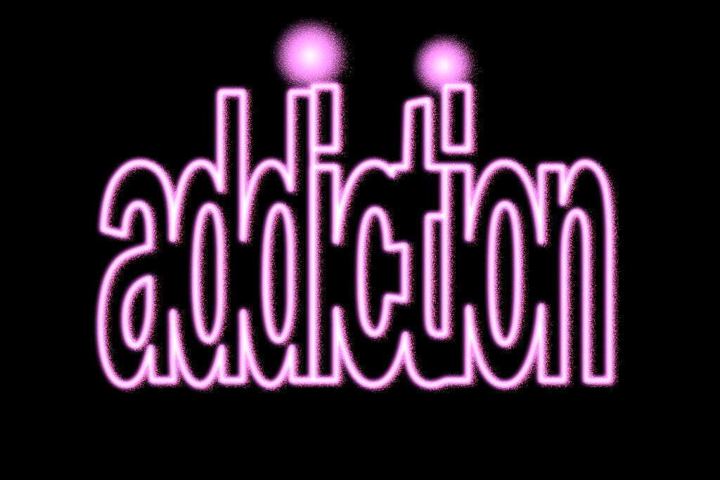 The word "addiction," outlined in pink