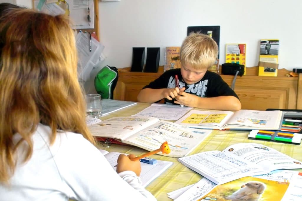 Boy & girl doing homework at table