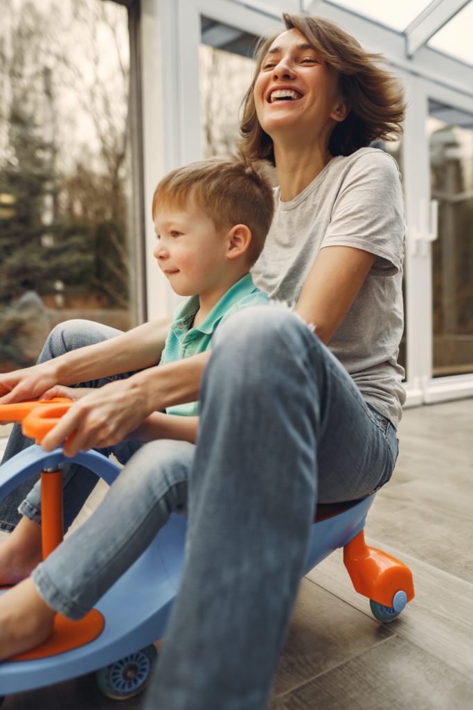 mom with preschool son on ride on toy