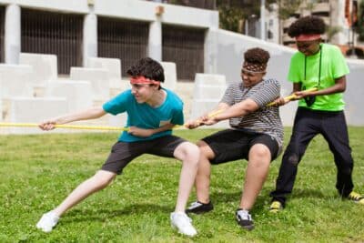 Group of teenage boys playing tug o war